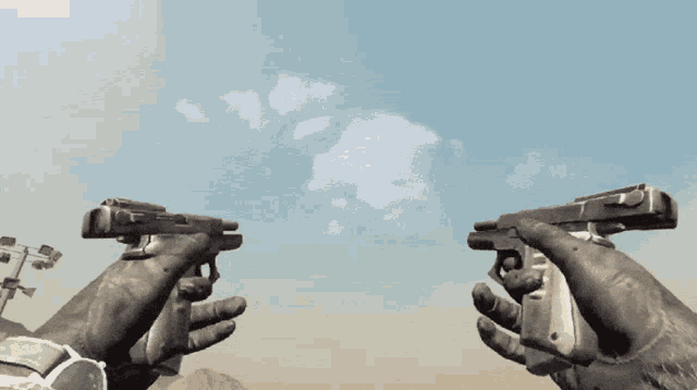 a person holding two guns in their hands with a blue sky in the background
