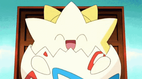 a cartoon character is sitting in a box with a star on its head .