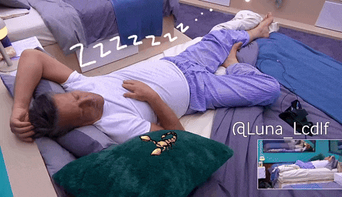 a man laying on a bed with a scorpion on a pillow