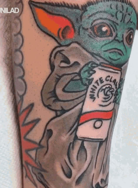 a tattoo of a baby yoda holding a white claw coffee