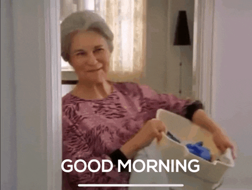 an elderly woman is holding a basket of laundry and says good morning