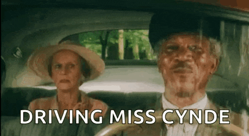 a man and a woman are sitting in a car .