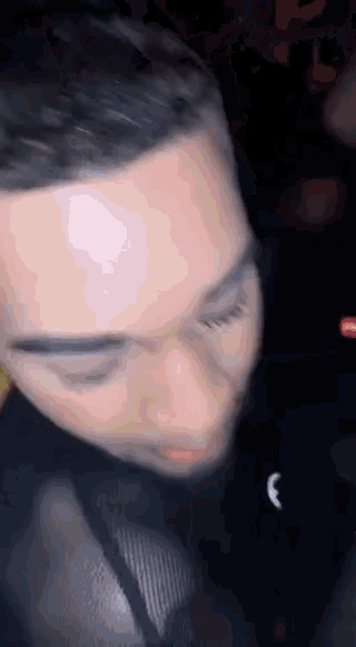 a close up of a man 's face with his eyes closed