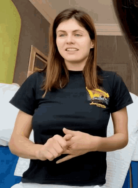 a woman wearing a black t-shirt that says ' aloha ' on it