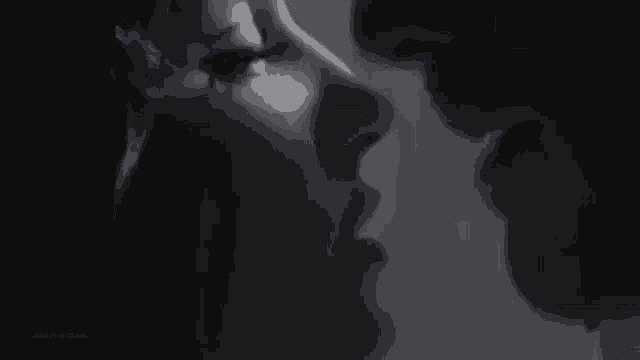 a black and white photo of a man and woman kissing each other .