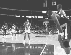 a black and white photo of a basketball game with a player wearing number 13