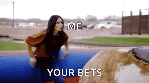 a woman is riding a bull in a rodeo and says `` me your bets ''