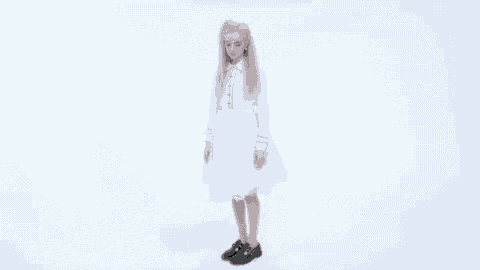 a woman in a white dress and black shoes is dancing .