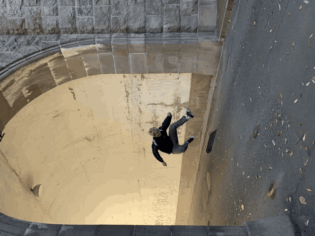 a person is falling down a staircase with a skateboard in the foreground