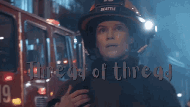 a woman wearing a seattle firefighter 's helmet stands in front of a red fire truck