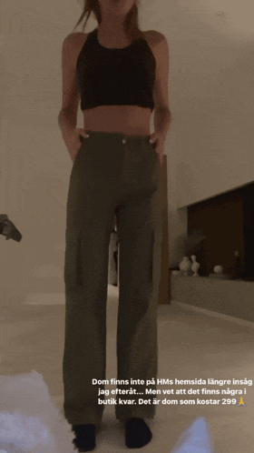 a woman is standing in a room with the words dom finns into on the bottom