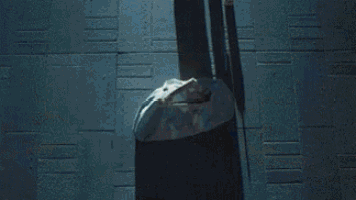 a close up of a person 's head with a light coming out of it in a dark room .