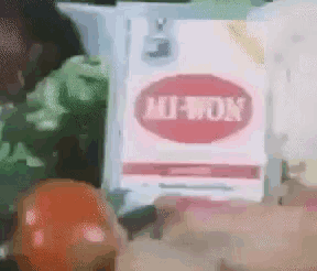 a box of hutton cigarettes sits on a table with vegetables