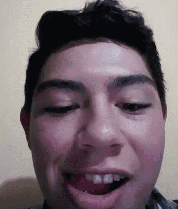 a close up of a man 's face with his mouth open .