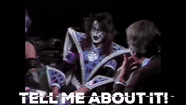 a man is talking to a woman in a costume with the words `` tell me about it '' .