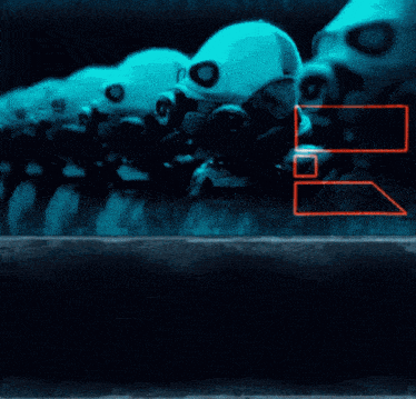 a row of robots wearing gas masks with the letter b visible