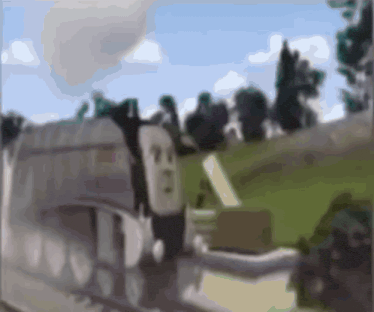a blurry picture of a train on the tracks