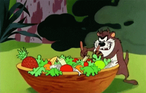 a cartoon of taz eating a salad with a spoon