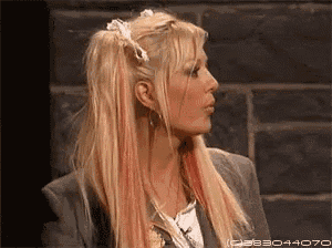 a woman with blonde and red hair is wearing a suit