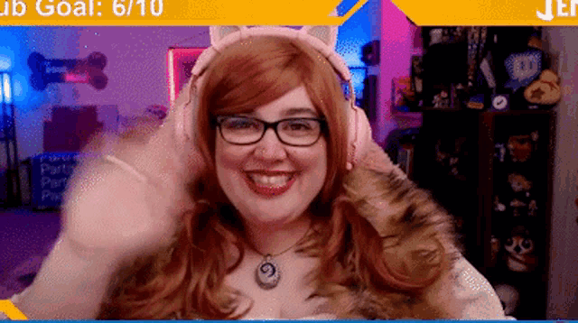 a woman wearing glasses and headphones is smiling and waving .