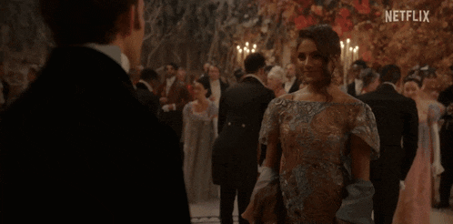 a man and a woman are dancing at a ball with netflix written on the bottom