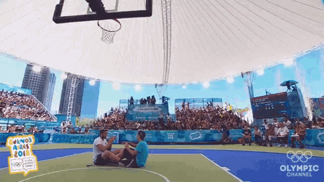 a basketball court with the olympic channel written on the bottom