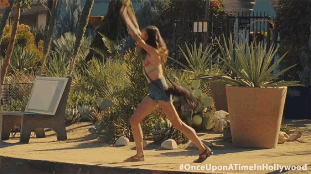 a once upon a time in hollywood advertisement features a woman in a bikini