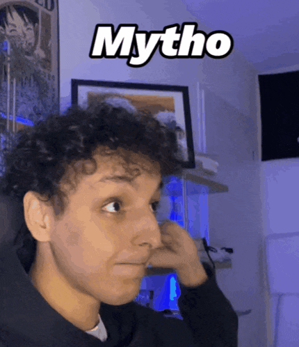 a man with curly hair has the word mytho written on his face