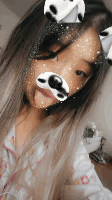 a girl is wearing a dog mask on her face and sticking her tongue out
