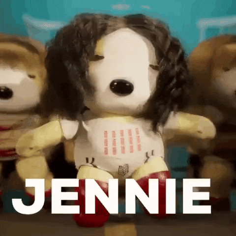a stuffed animal with a wig and the name jennie on it is standing next to other stuffed animals .