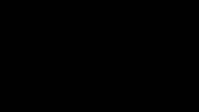 a man in a black shirt is standing in a body of water with trees in the background