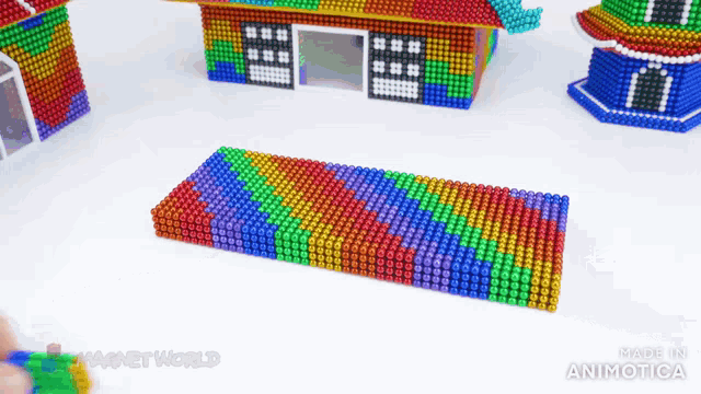 a bunch of colorful beads are stacked on top of each other with the words made in animatica on the bottom
