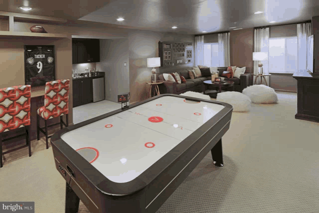 a game room with a pool table and a sign that says tucker on it