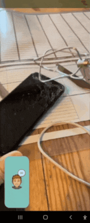 a phone with a broken screen sits on a table