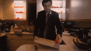 a man is cutting an apple on a cutting board