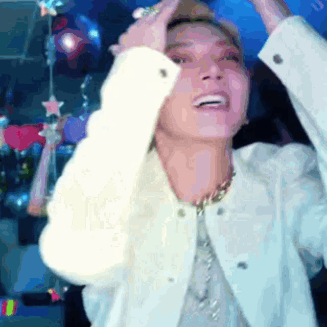 a woman in a white jacket is holding her head in her hands