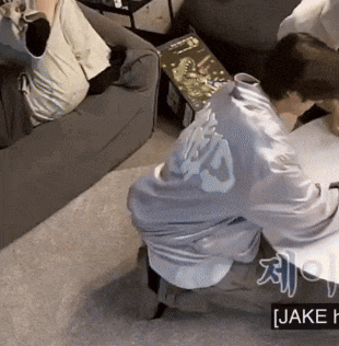 a person sitting on a couch with the name jake on the bottom