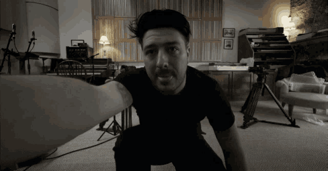 a man in a black shirt takes a selfie