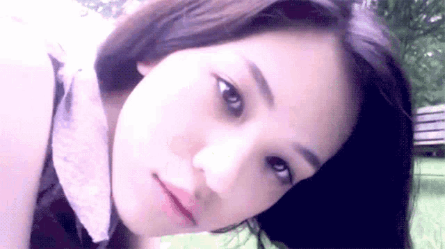 a close up of a woman 's face with a white background
