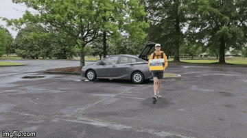a man is running in a parking lot with an imgflip.com watermark on the bottom