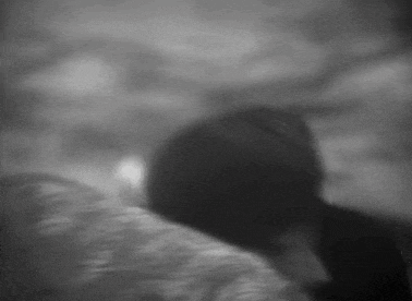 a blurry black and white photo of a person 's face