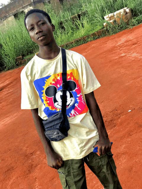 a young man wearing a mickey mouse tie dye t-shirt