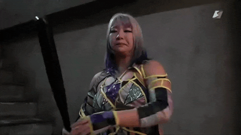 a woman is tied up with a rope and holding a sword in her hands .