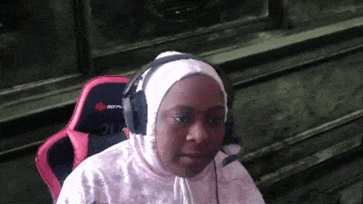 a young girl wearing headphones and a hijab is sitting in a chair .