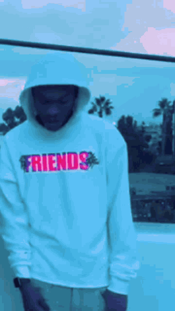 a man wearing a hoodie that says friends