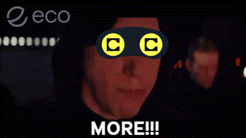 a man wearing a mask with the letter c on it is screaming with the word more below him