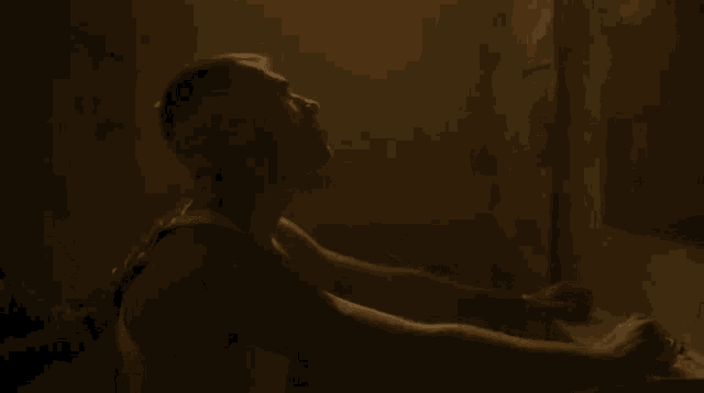 a man and a woman are hugging in a dark room .