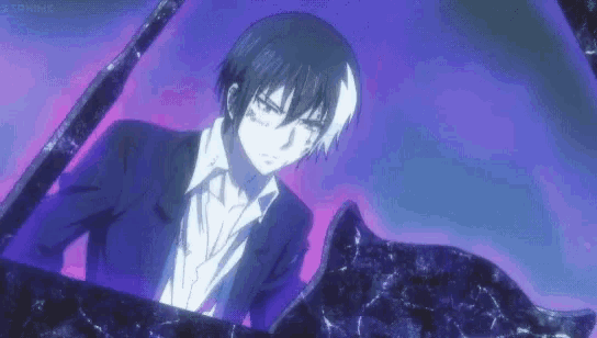 a man in a suit and tie is standing next to a cat in a purple room .