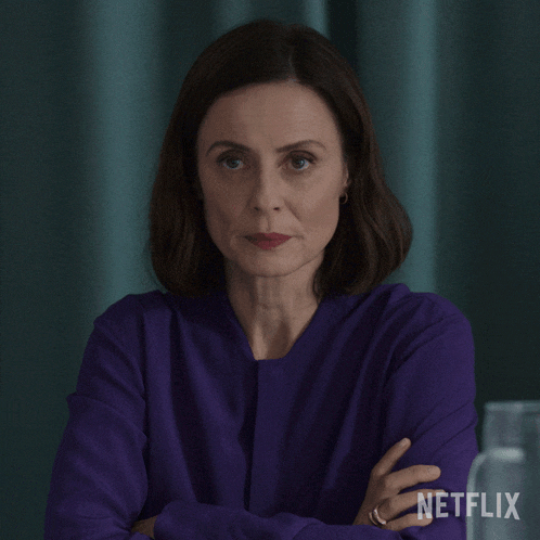 a woman in a purple shirt with a netflix logo on the bottom