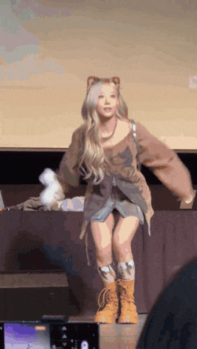 a woman in a bear costume is dancing on the stage